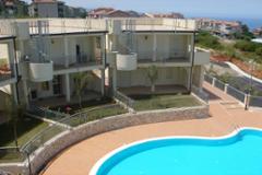 Sea-view apartments with private garden and communal pool. 
